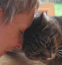 Becs Stevens animal communicator touching heads with her Tabby cat Tess